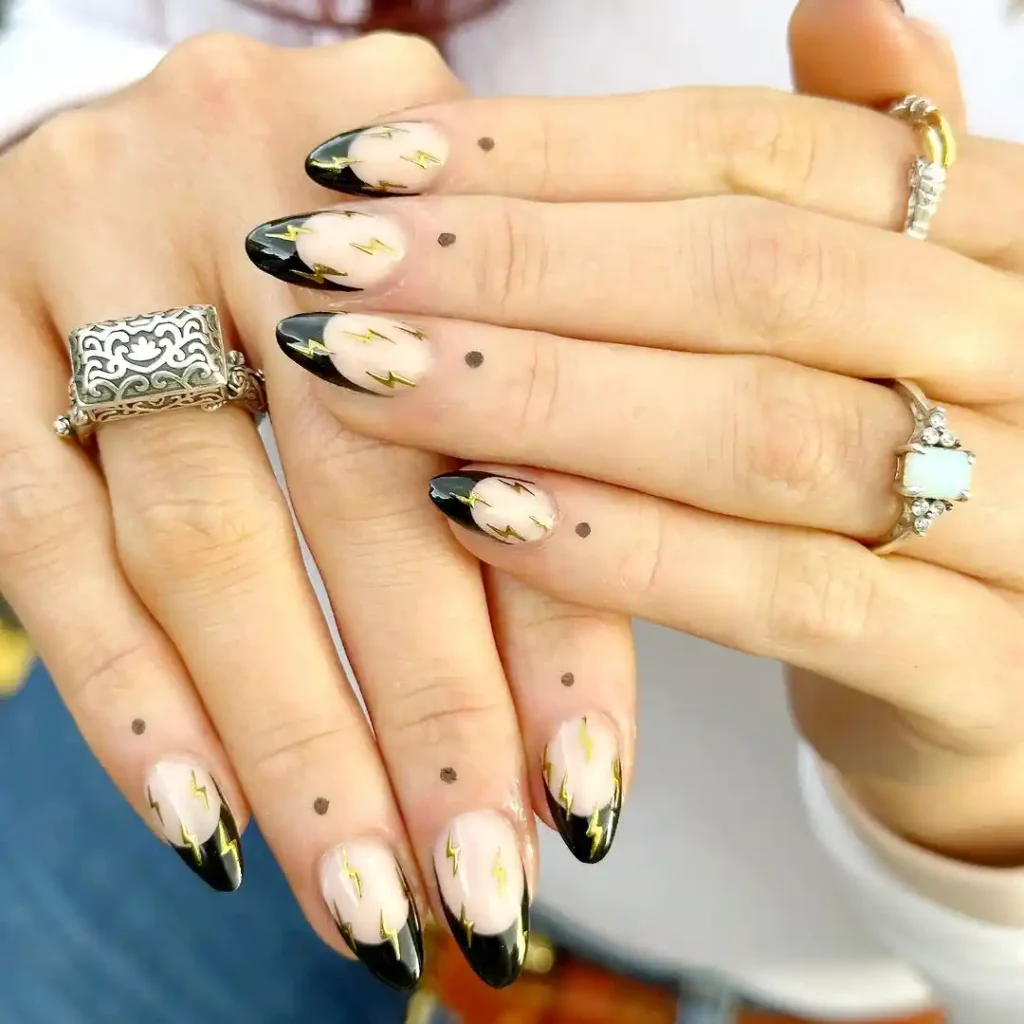 Black French tips with chrome thunder nail art.