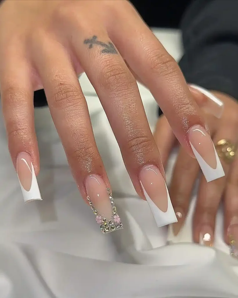 Simple wedding nails with white French tips and crystal nail art. 