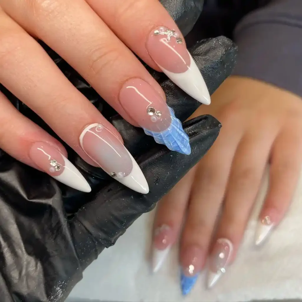 Long almond French manicure with blue and white nail color combination and 3D gel art. 
