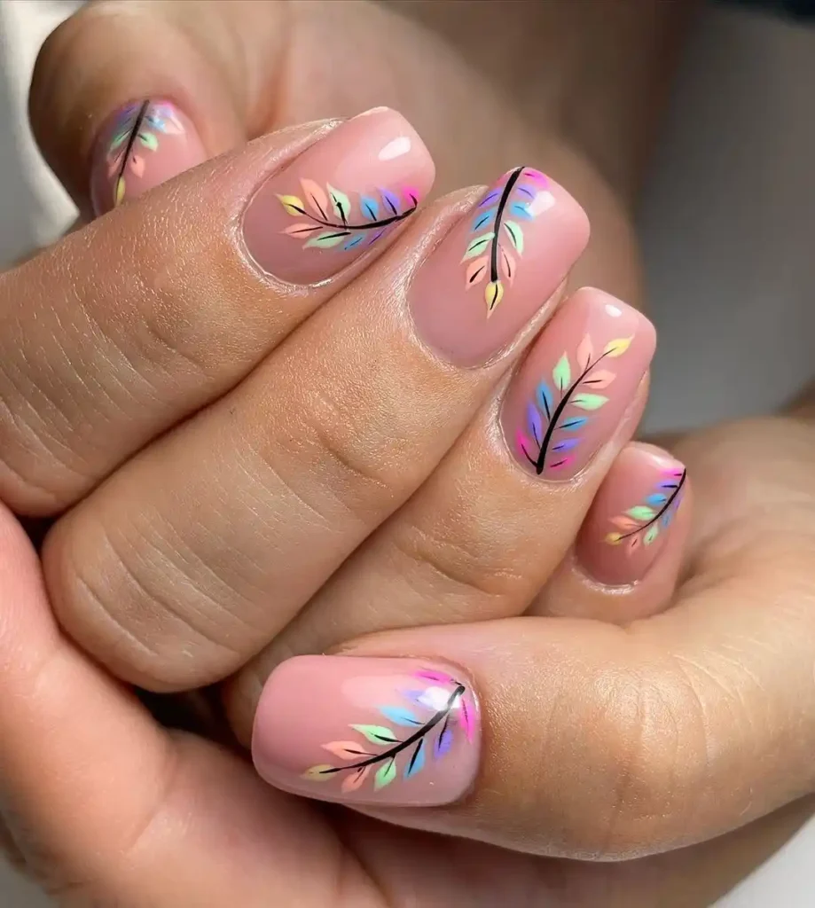 Colorful leafy nail art on short nude squoval nails. 