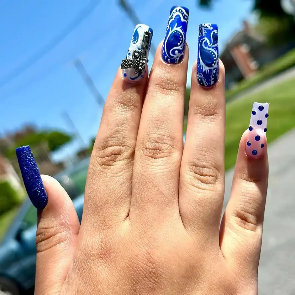 Blue and white bandana nail design on long acrylic nails.