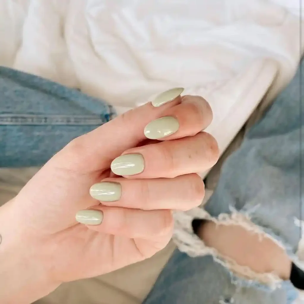 Short round nails with sage green nail color. 