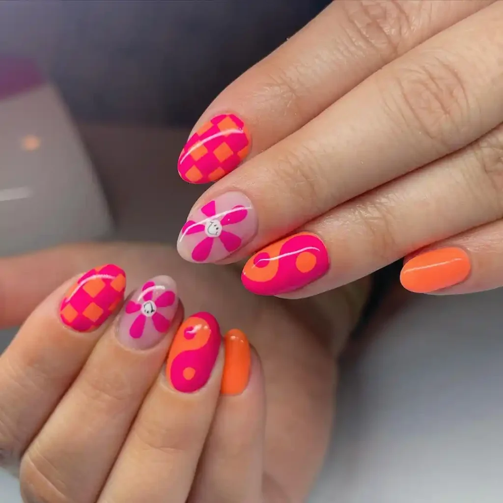 Cute pink and orange nail color combination with mixed summer nail art.