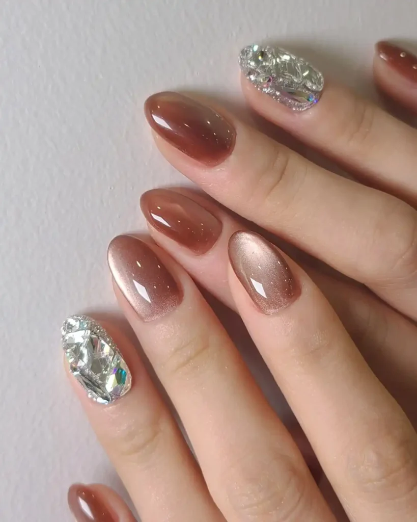 Beautiful gemstone nails with silver and brown nail color combination and marble effect. 