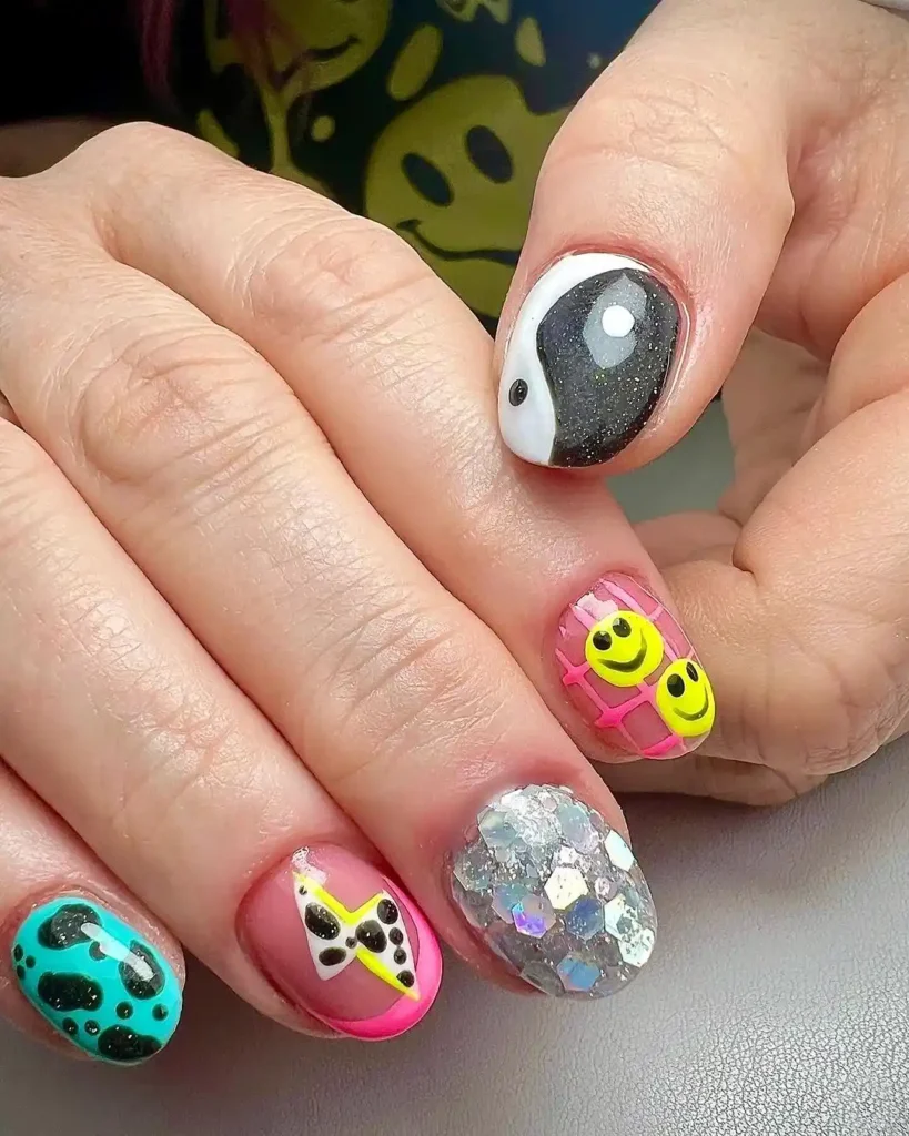 Festival nail art with holographic glitters, thunder patterns, and blob designs. 