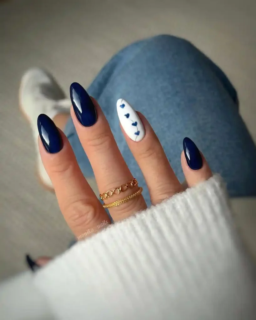 Blue and white winter nail idea with simple heart designs. 