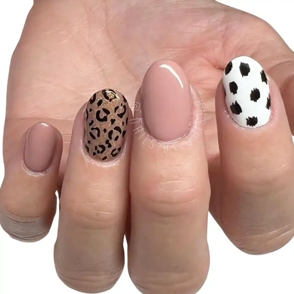 Animal print designs on short nude nails.