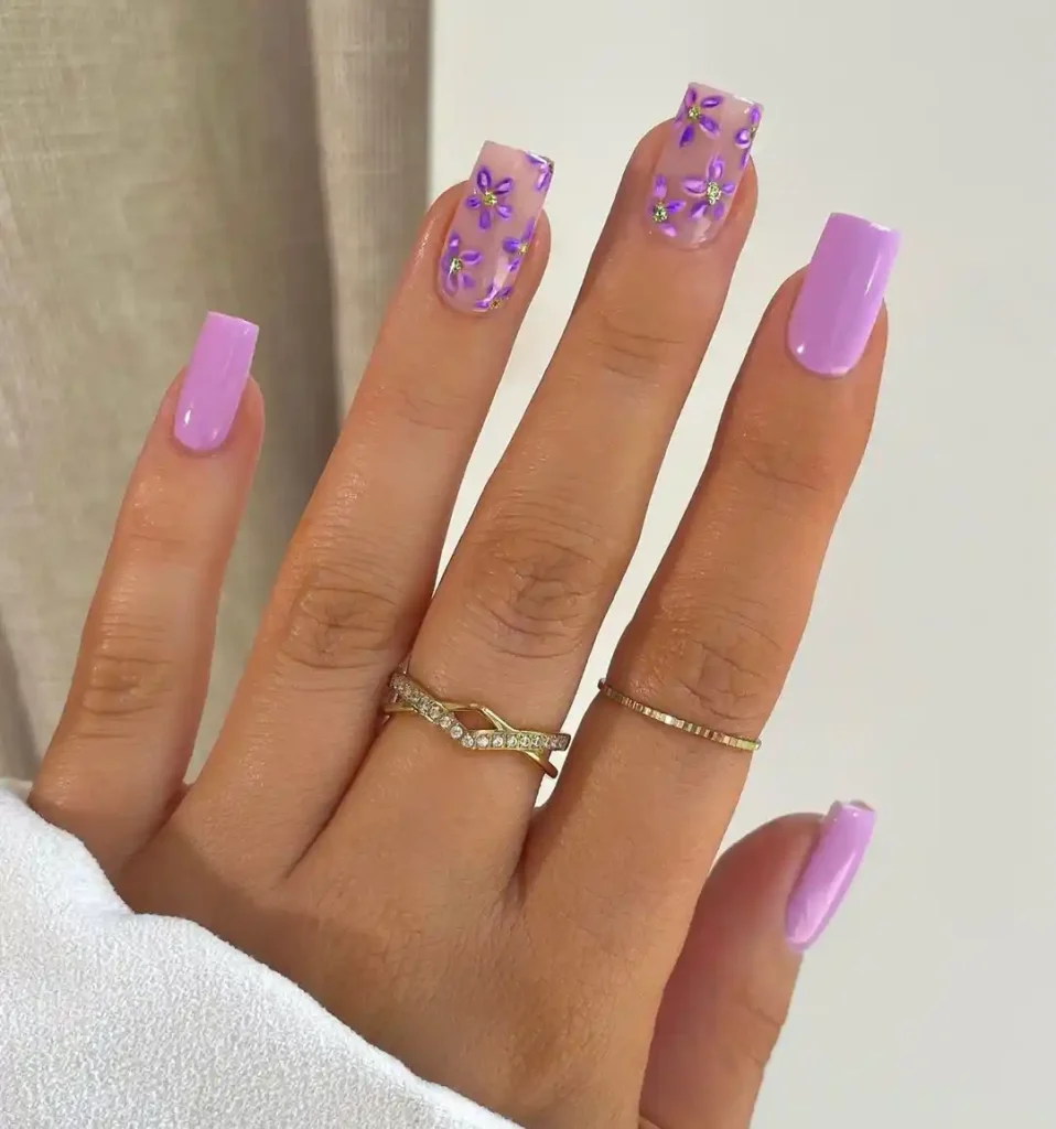 Summer nails with purple nail color and flower art. 