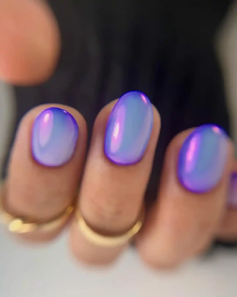 Simple and bright gel nails with purple nail polish and shine. 