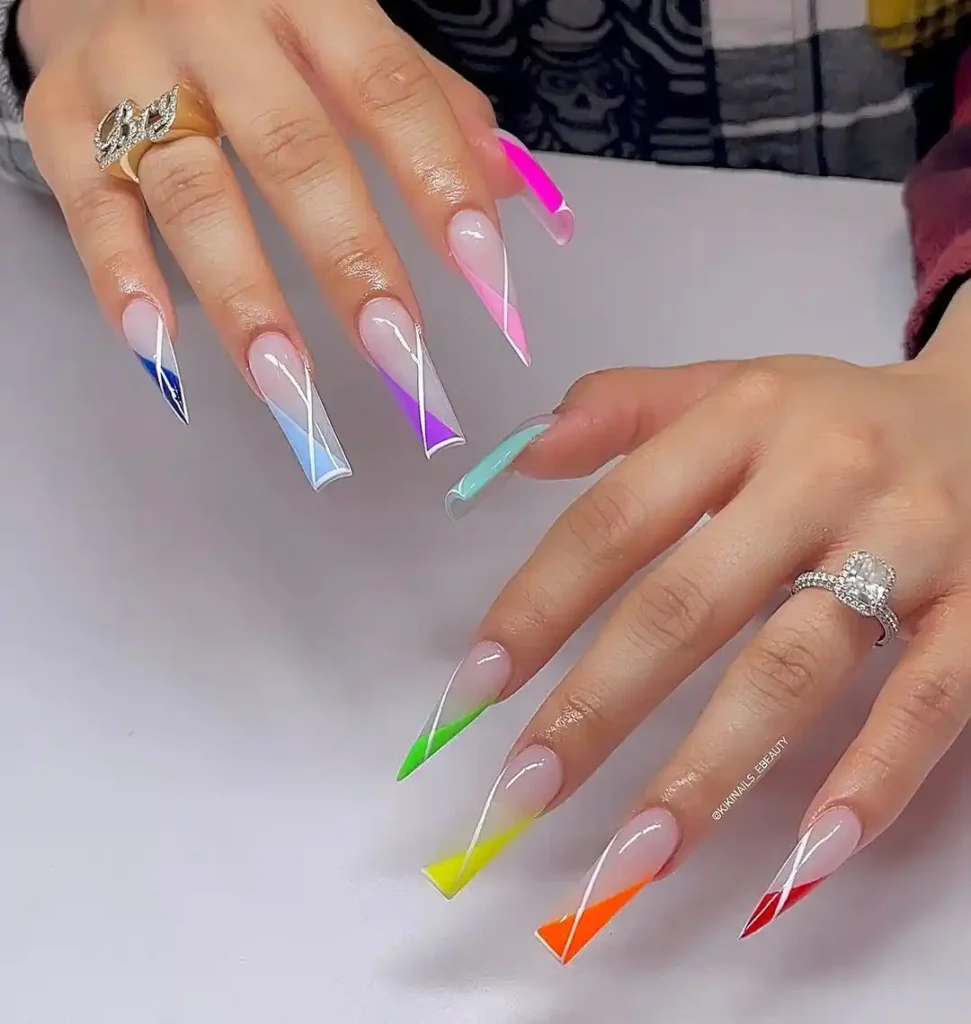 Long square and stiletto nails with bright colorful crossover tips.