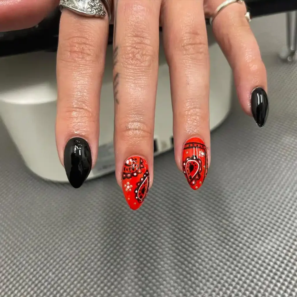 Hand-painted bandana nail design with black and red nail polish. 