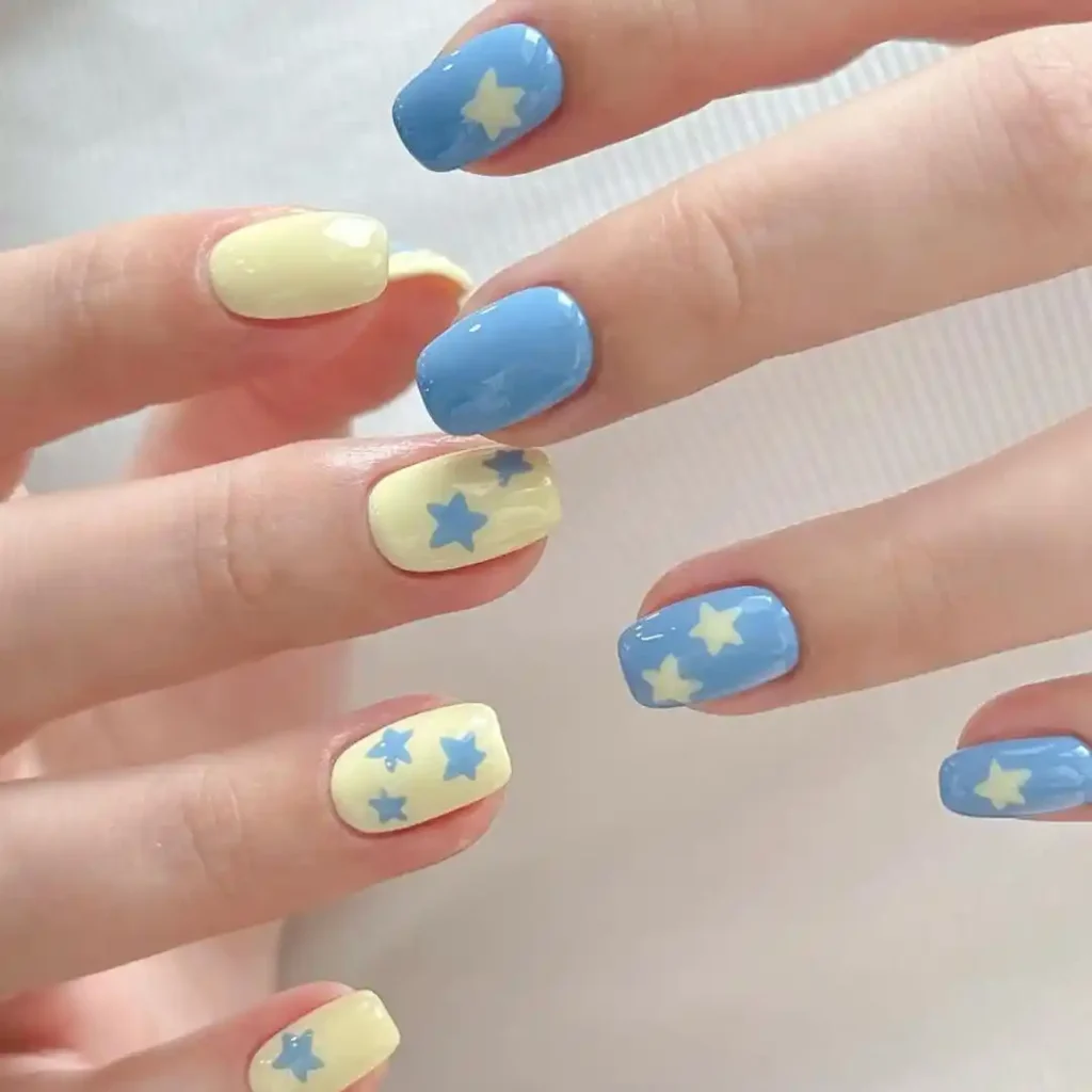 Simple and cute summer star nail design with blue and white nail colors.