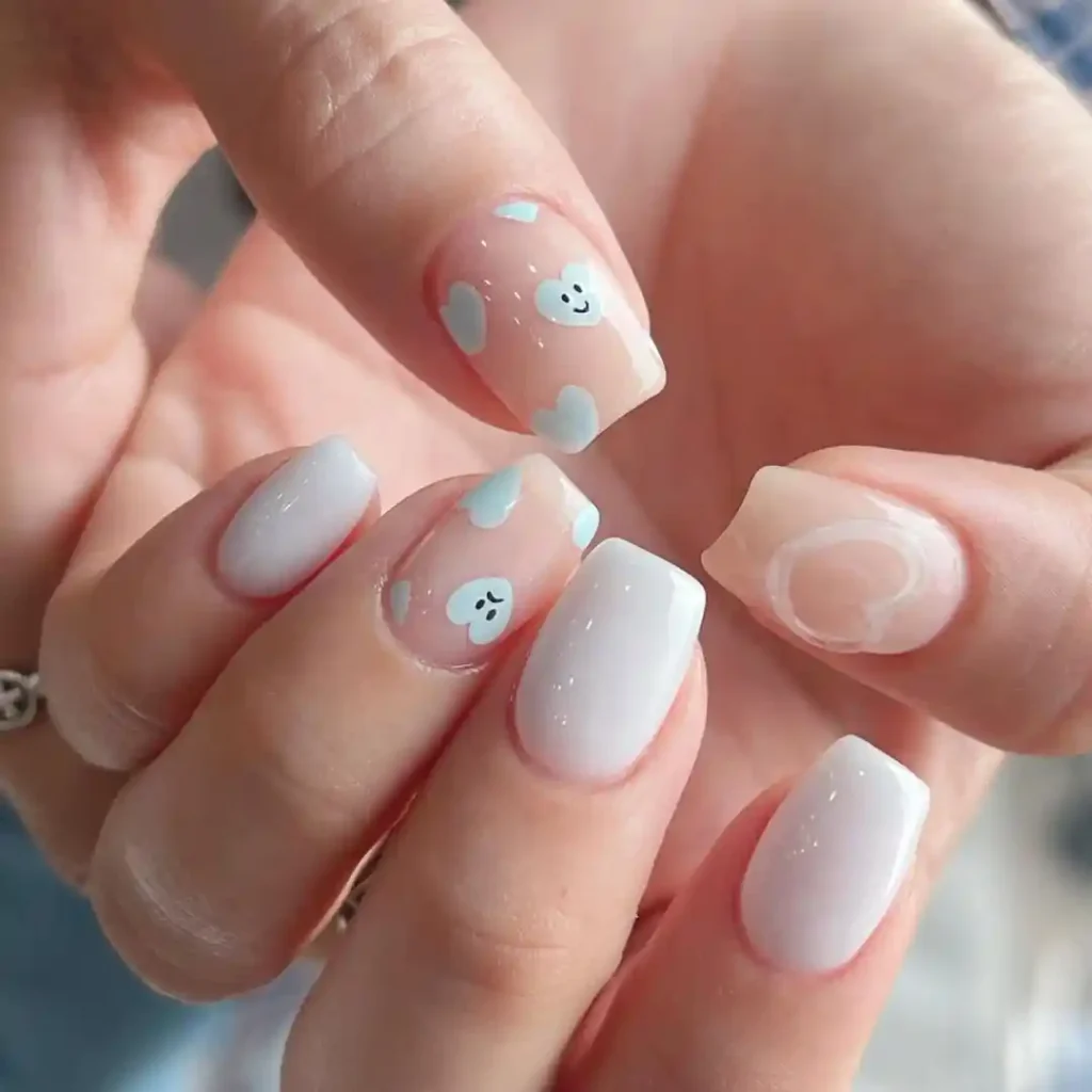 White summer nails with cute heart designs. 