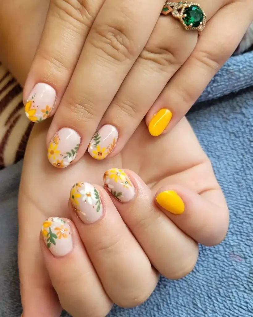 Yellow fall nails with cute flower nail art.
