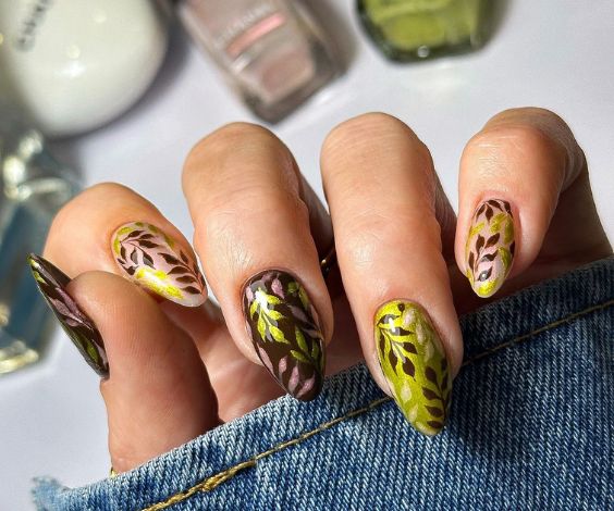 Olive green and brown nails with leafy nail art for fall. 
