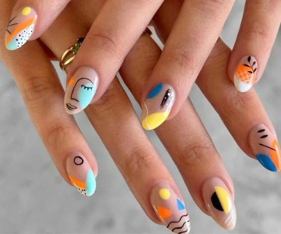 Colorful abstract nail art on short nude nails.