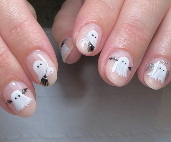 Cute white ghosts on short nude nails. 