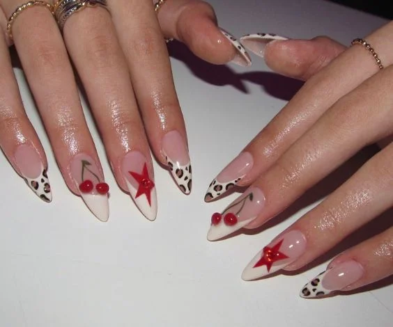 Rodeo-inspired nail art for birthdays with cherry and cow print nail art. 