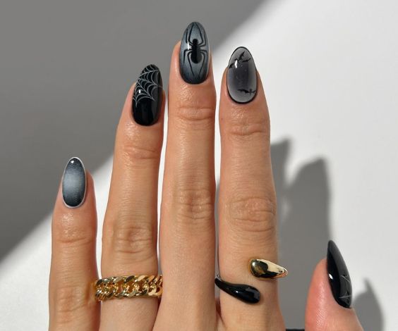 Almond nails with black and grey nail colors. 