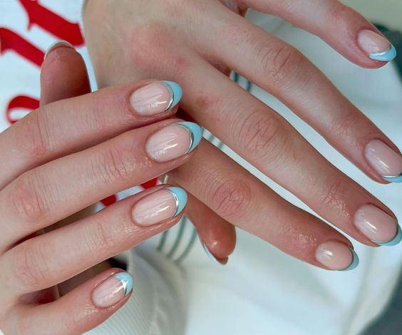 Short natural nails with baby blue and metallic double French tips. 
