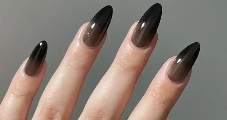 Soft ombre nail effect on black almond nails. 
