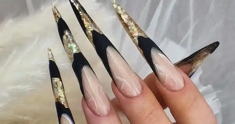 Extra long Russian almond nails with black and gold nail art. 
