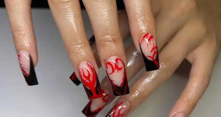 Black French tips and red fire nail art on short square nails. 
