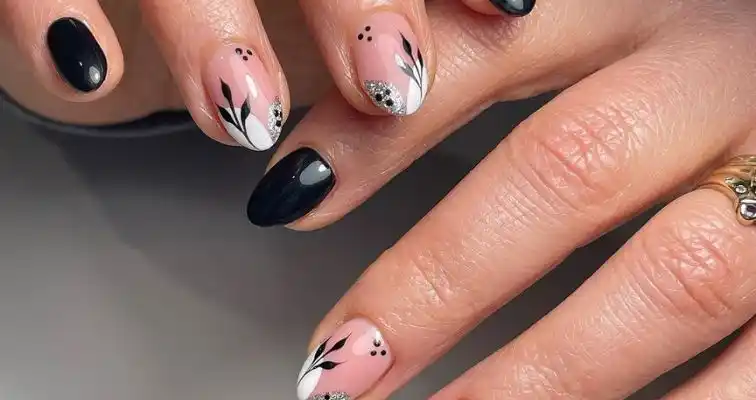 Cute short nails with black and white leafy nail art. 