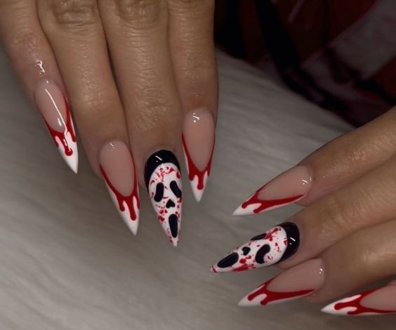 Pointed Halloween nails with blood and nun designs. 