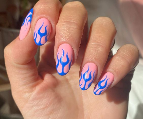 Pink oval nails with blue flames nail art. 