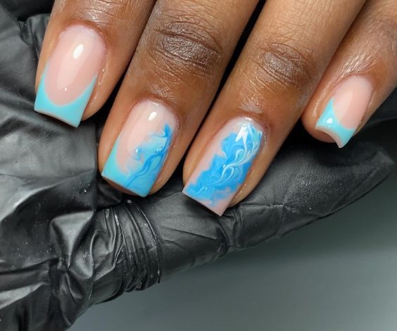 Medium square nails with blue marble nail art.