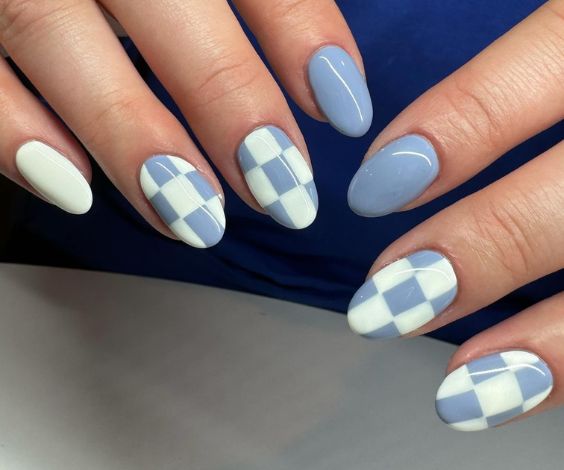 Checkered nail art with blue and white nail colors.