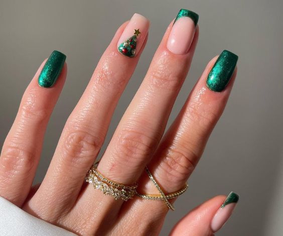 Short green square nails with Christmas tree nail art. 
