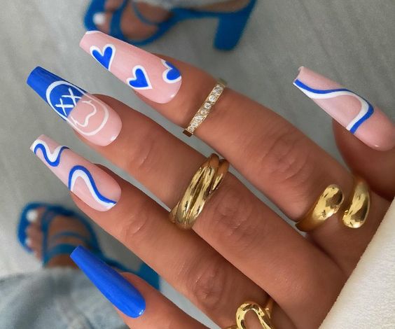 Coffin acrylic nails with blue and white nail art. 