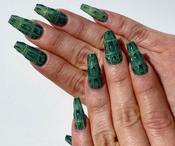 Coffin nails with dark green crocodile nail art. 