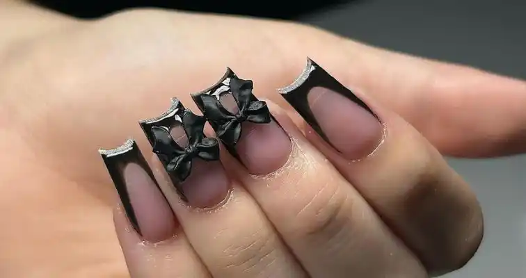 Short coffin nails with black French tips and coquette bows. 
