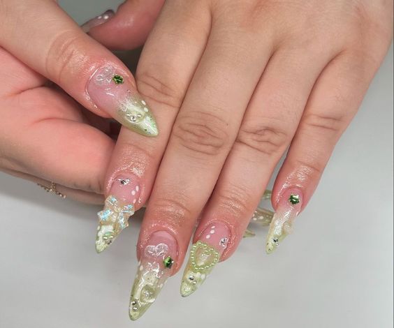 Acrylic almond nails with glitter ombre effect and 3D nail art. 