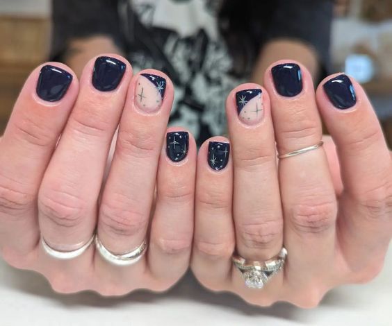 Nighttime nail art with dark blue nail color. 