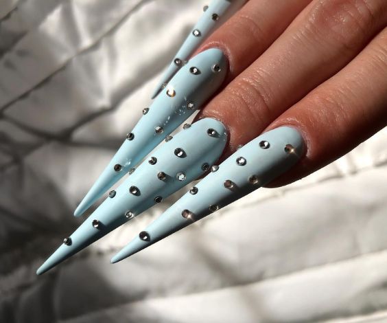 Long baby blue stiletto nails with 3D crystals. 