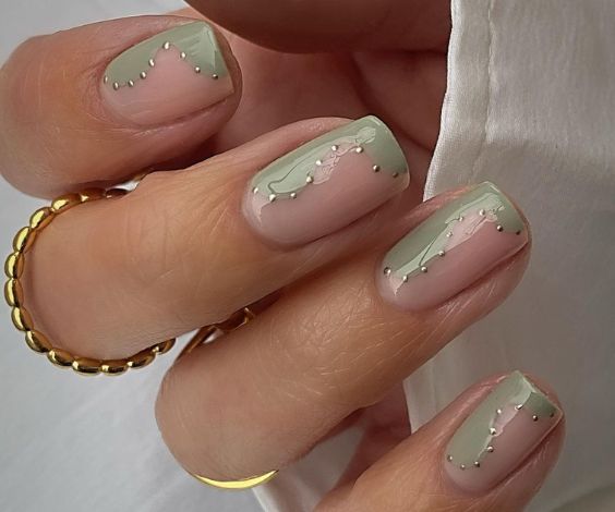 Sage green nail design with metallic dots art. 