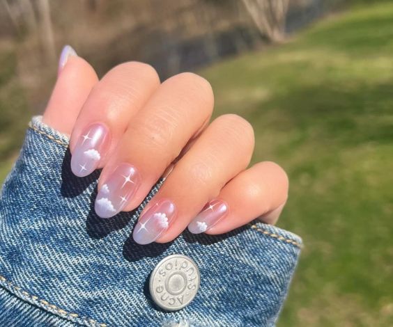 Light blue ombre nails with dreamy cloud nail art.  
