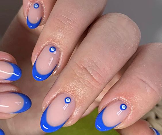 Royal blue French tips and evil eye designs.