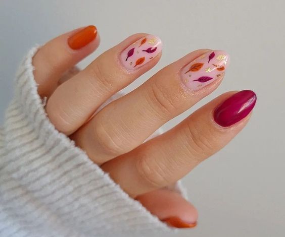 Falling leaves nail art with orange and cherry red nail colors