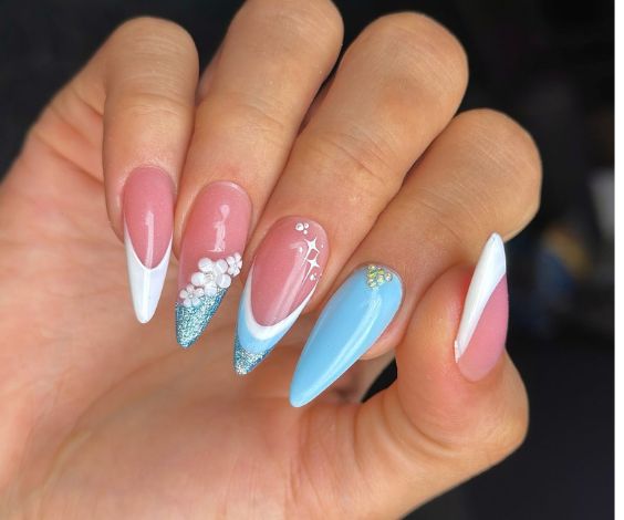 Baby blue nails with acrylic flowers and French tips.