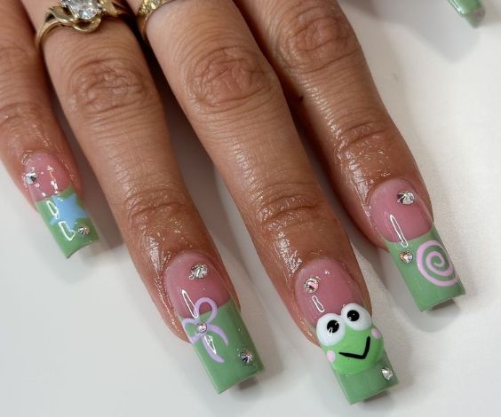 Green French tips with cute acrylic frog and bow nail art. 
