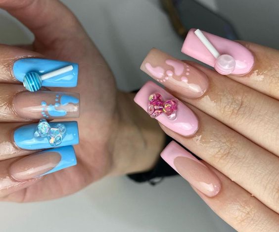 Cute pink and blue medium square nails with gender reveal-themed 3D art.