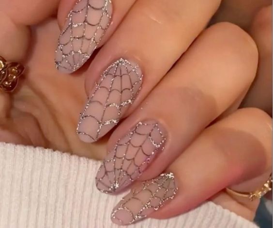 Nude nail base and glitter polish for spider web designs. 