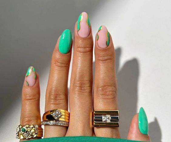 Simple nail design with mint green and metallic gold nail colors. 