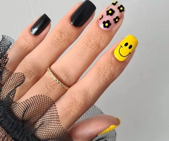 Good day yellow and black nail art for bright and joyful birthday manicures.