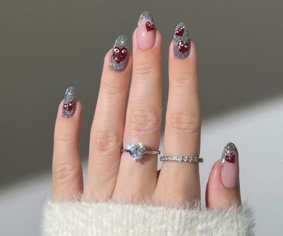 Cute heart designs on silver glitter nails. 